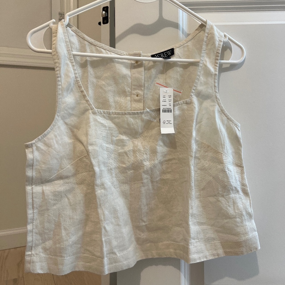 White sleeveless blouse with buttons in the back